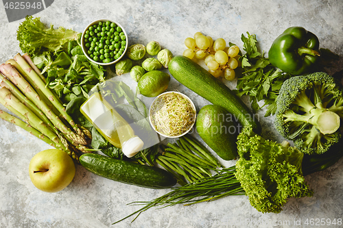 Image of Green antioxidant organic vegetables, fruits and herbs placed on gray stone