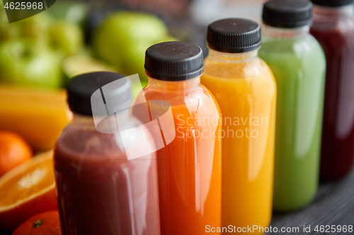 Image of Colorful bottles filled with fresh fruit and vegetable juice or smoothie