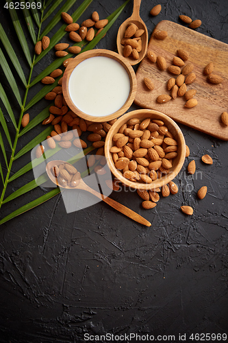 Image of Close up of Almonds in wooden bowl and almond milk