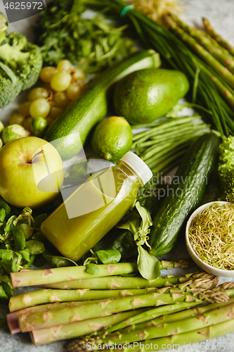 Image of Green antioxidant organic vegetables, fruits and herbs placed on gray stone