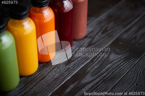 Image of Colorful bottles filled with fresh fruit and vegetable juice or smoothie