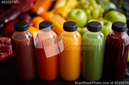Image of Colorful bottles filled with fresh fruit and vegetable juice or smoothie