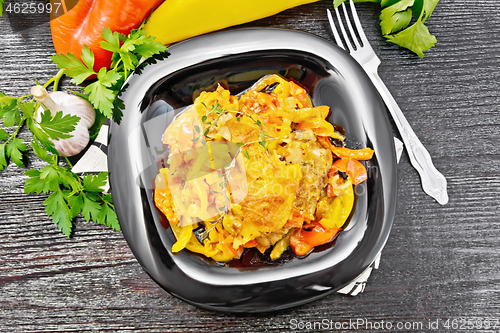 Image of Chicken with pepper in plate on black board top