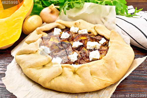 Image of Pie with pumpkin and onions on board