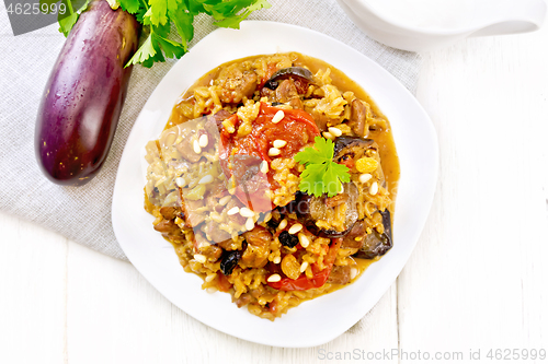 Image of Rice with vegetables and chicken in plate on board top