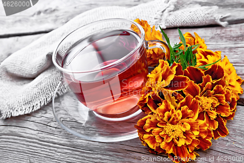 Image of Tea herbal of marigolds in glass cup on gray board