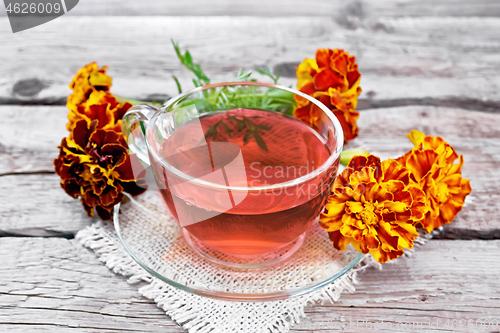 Image of Tea herbal of marigolds in cup on board
