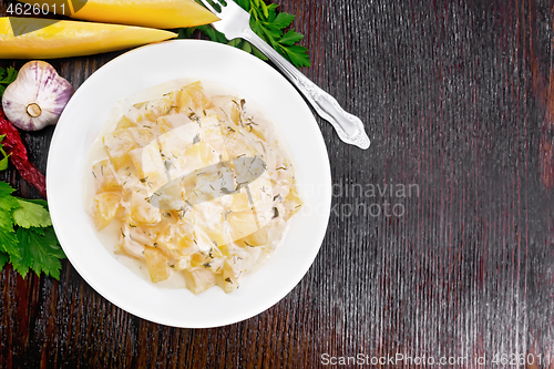 Image of Pumpkin with sour cream sauce in plate on wooden board top