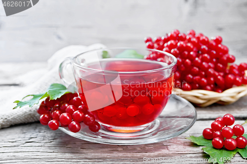 Image of Tea from viburnum in cup with berries on board