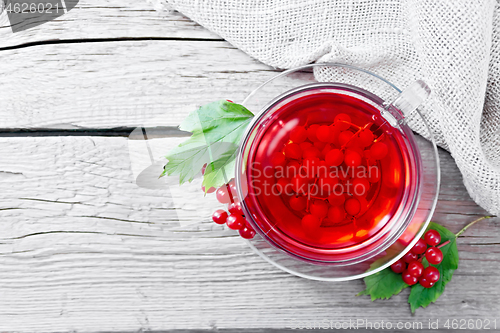 Image of Tea from viburnum in cup with berries on board top