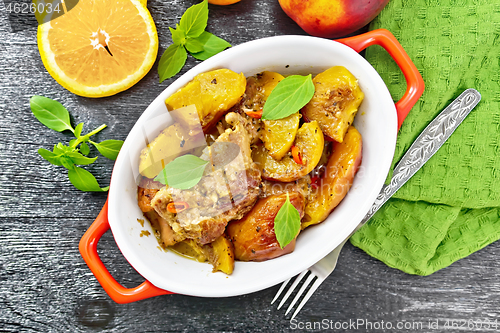 Image of Turkey with peaches in pan on black board top