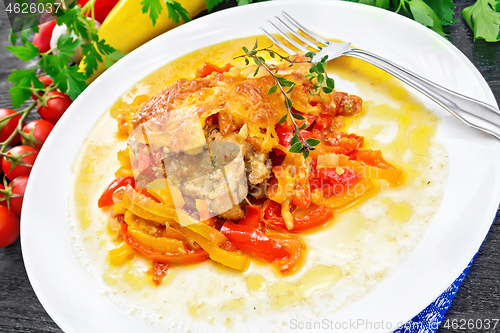 Image of Chicken with pepper in white plate on board