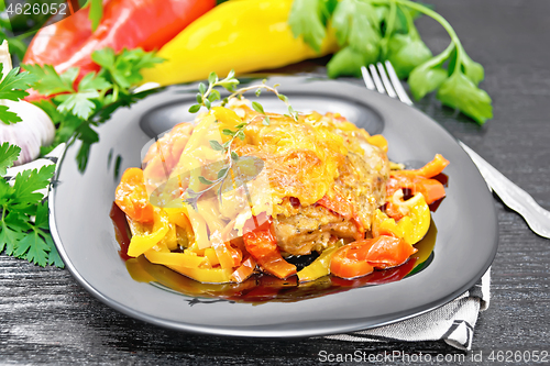 Image of Chicken with pepper in plate on black board