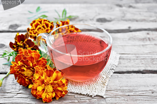 Image of Tea herbal of marigolds in cup on napkin
