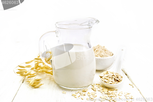 Image of Milk oatmeal in jug on white wooden board