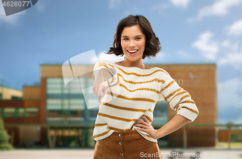 Image of young woman pointing finger to you over school