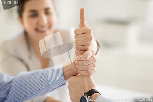 Image of group of business team making thumbs up gesture