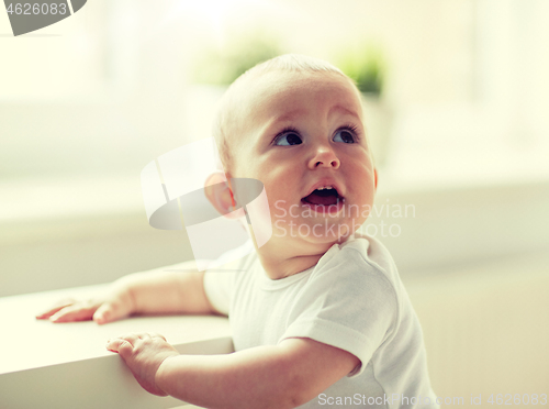 Image of happy little baby boy or girl at home