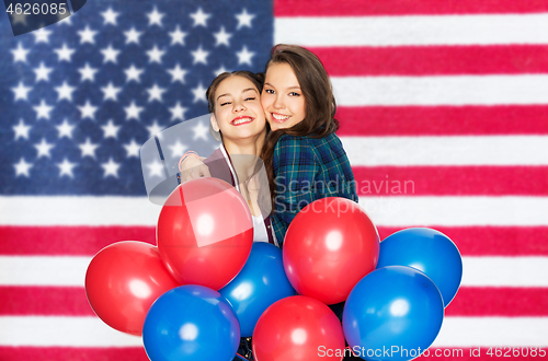 Image of teenage girls with balloons over american flag