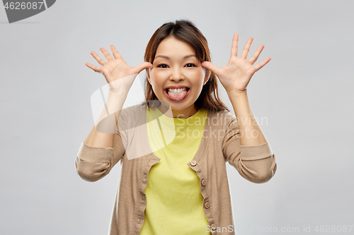 Image of funny asian woman making silly faces