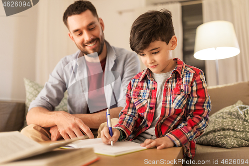 Image of father and son doing homework together