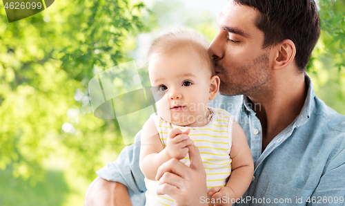 Image of father kissing little baby daughter