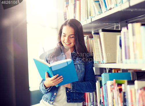 Image of high school student girl reading book at library