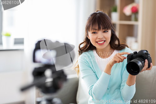 Image of asian female blogger with camera recording video