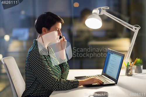 Image of businesswoman calling on smartphone at office