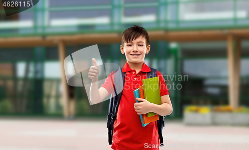 Image of student boy with books and bag showing thumbs up