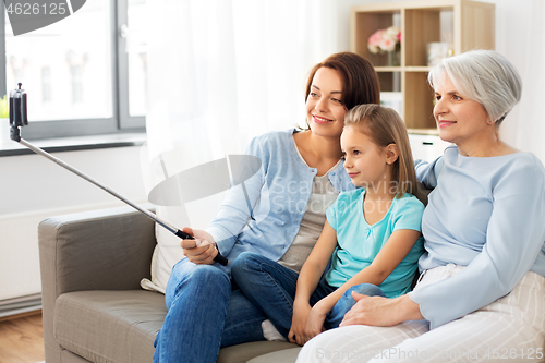 Image of mother, daughter and grandmother taking selfie