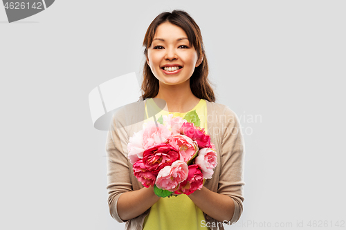 Image of happy asian woman with bunch of flowers