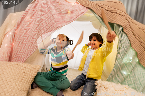 Image of boys with pots playing in kids tent at home