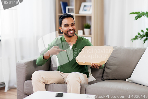 Image of indian man with box of takeaway pizza at home