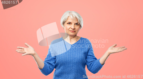 Image of senior woman having no idea and shrugging