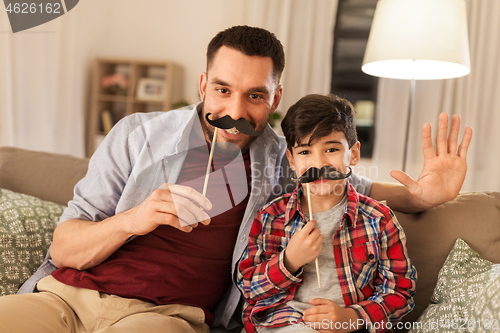 Image of father and son with mustaches having fun