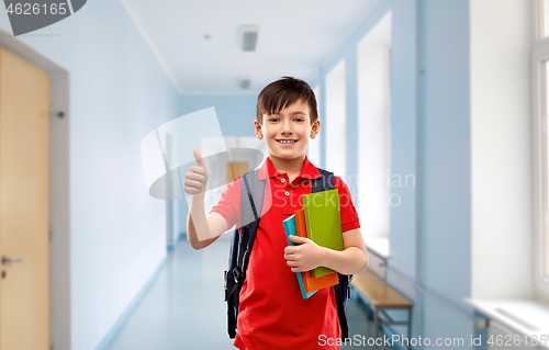 Image of student boy with books and bag showing thumbs up