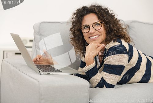 Image of Beautiful woman working at home