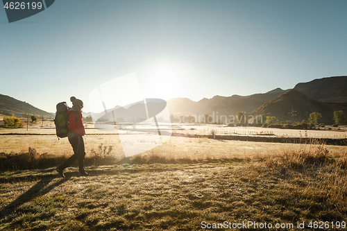 Image of Woman walking with a backpack