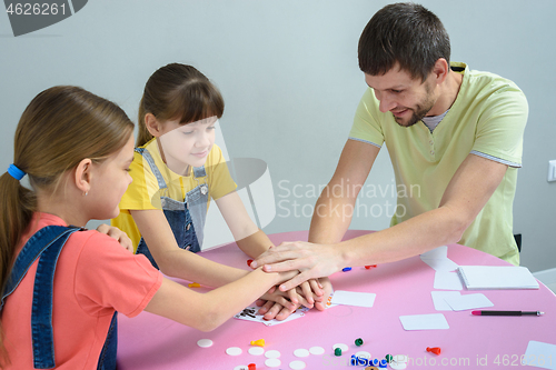 Image of Dad and kids have fun playing a board game
