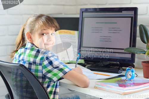 Image of Girl 7-9 years old happy to work on the computer