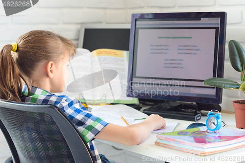 Image of Girl doing homework on the computer at home