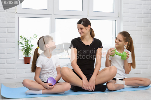 Image of Girls\' fitness classes with their mom at home