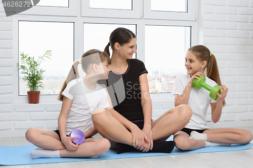 Image of positive fitness at home mom and daughters