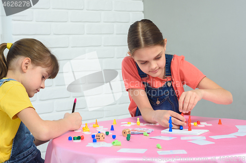 Image of Two sisters play a board game