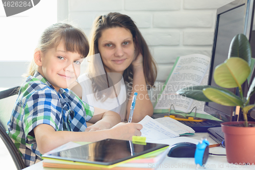 Image of tutor helps the student with homework on the computer