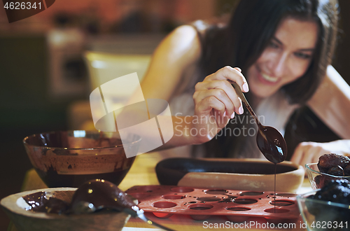 Image of Staying at home woman preparing handmade vegetarian chocolate tr