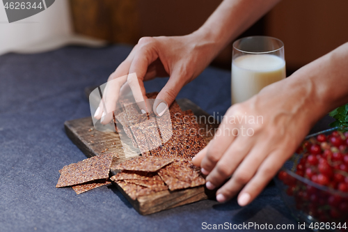 Image of Vegan woman serving flaxseed bread