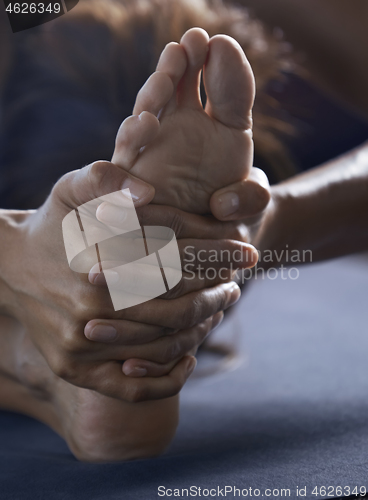 Image of Close-up of the man doing yoga stretching exercise