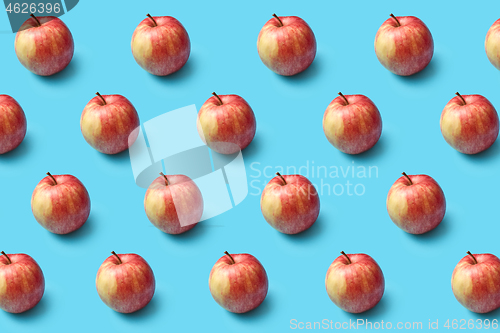 Image of Fresh natural organic apples pattern on a blue background.
